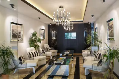 a living room with white furniture and a chandelier at Kavala Hotel in Bursa