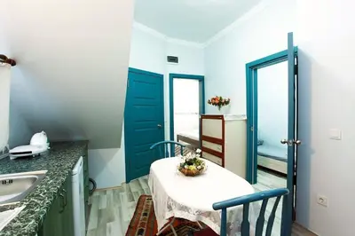 a kitchen with a table and a blue door at Blue Suites by V in Istanbul