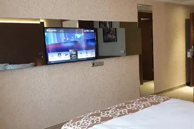 a hotel room with a bed and a flat screen tv at Wyndham Cerkezkoy in Cerkezkoy