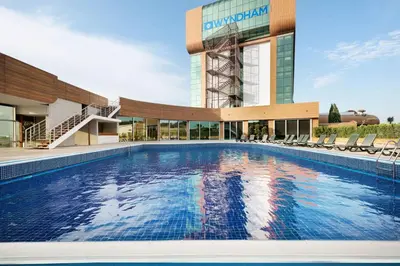 a large swimming pool in front of a building at Wyndham Cerkezkoy in Cerkezkoy