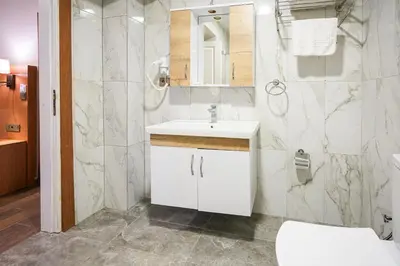 a bathroom with a white sink and a shower at Seatanbul Hotel in Istanbul