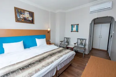 a bedroom with a large bed and two chairs at Seatanbul Hotel in Istanbul