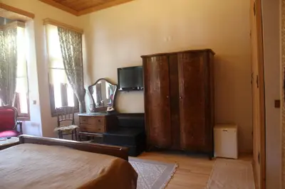 a bedroom with a bed and a wooden cabinet at Tom Square Boutique Hotel in Istanbul