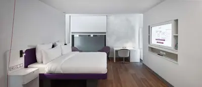 a hotel room with a bed and a tv at YOTELAIR Istanbul Airport, Duty free - International Transit area in Istanbul