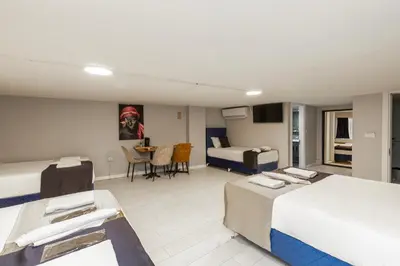 a hotel room with two beds and a table at Sirkeci Grand Family Hotel & SPA in Istanbul
