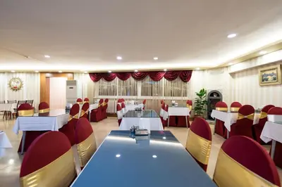 a dining room with tables and red chairs at DİNAR HOTEL in Istanbul