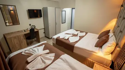 a hotel room with two beds with towels on them at La Fortuna Taksim Hotel in Istanbul