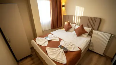 a bedroom with a bed with bows on it at La Fortuna Taksim Hotel in Istanbul