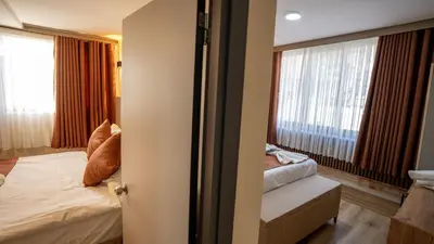 a bedroom with a bed and a window with curtains at La Fortuna Taksim Hotel in Istanbul