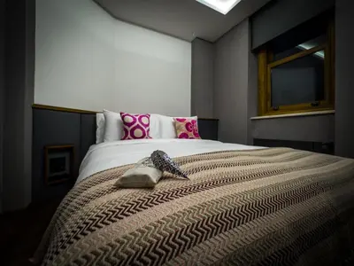 a bedroom with a large bed with pink pillows at Blu Hotel in Istanbul