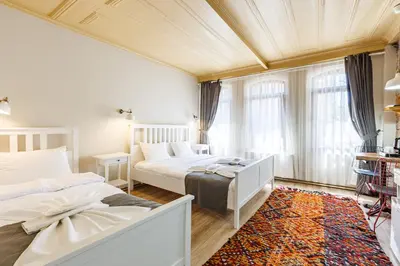 a bedroom with two beds and a couch at Hotel Miro Mansion Old City in Istanbul