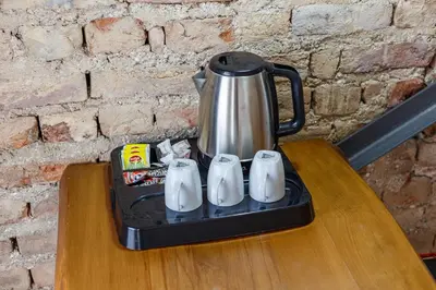 a tea kettle sitting on a table on top of a table at Hotel Miro Mansion Old City in Istanbul