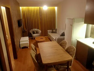 a living room with a wooden table and a couch at FALCON PalaS OTEL in Istanbul