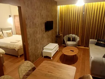 a hotel room with a bed and a living room at FALCON PalaS OTEL in Istanbul