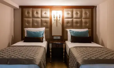 a hotel room with two beds and a headboard at Hotel The Pera Hill in Istanbul