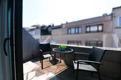 a balcony with two chairs and a table with a plant at Inncity Hotel Nisantasi in Istanbul