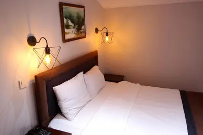 a bedroom with a white bed with lights on it at Sheriff Residence in Istanbul