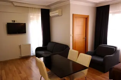 a living room with a black table and chairs at Sheriff Residence in Istanbul