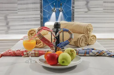 a plate of fruit on a table with a glass of orange juice at Vital Thermal Hotel & SPA in Termal