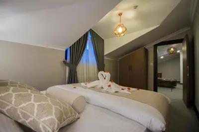 a hotel room with two beds with towels on them at Hit Suites Avcilar Hotel in Avcılar
