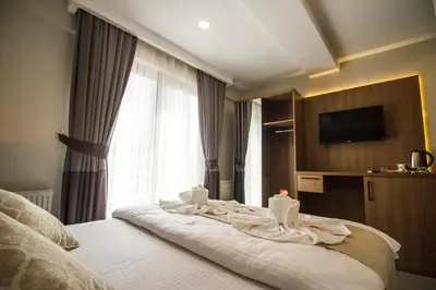 a hotel room with a bed with towels on it at Hit Suites Avcilar Hotel in Avcılar