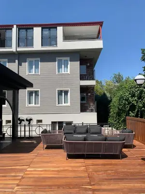 a building with a deck with couches and a building at Istanbul Park Hotel in Tuzla