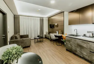 a kitchen and living room with a couch and a table at Kızılkaya Business Otel in Korfez