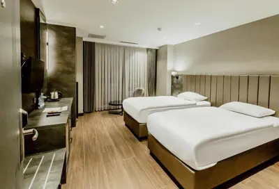 a hotel room with two beds and a television at Kızılkaya Business Otel in Korfez