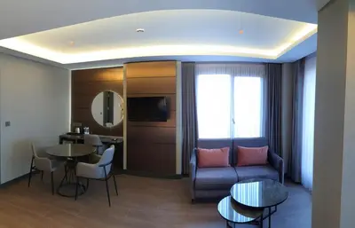 a living room with a couch and a table at Kızılkaya Business Otel in Korfez