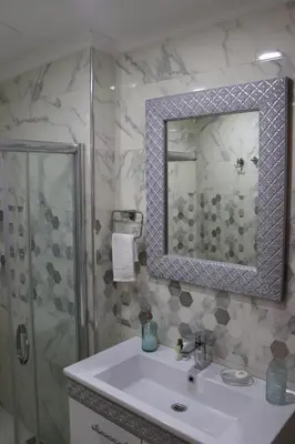 a bathroom with a white sink and a shower at Yankı Hotel in Çekirge
