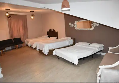 a hospital room with three beds and a mirror at Yankı Hotel in Çekirge
