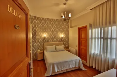 a small bedroom with a bed and a window at Mimoza Butik Otel Buyukada in Buyukada
