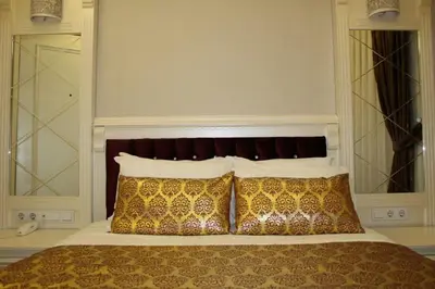 a bedroom with a bed with two pillows at Hotel Coliseum in Istanbul