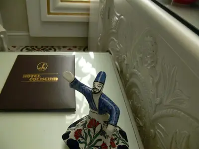 a figurine of a man on a table next to a box at Hotel Coliseum in Istanbul