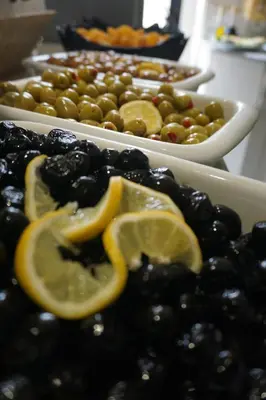 a plate of food with lemons and green olives at Hotel Coliseum in Istanbul
