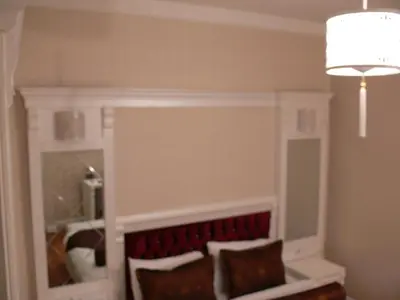 a bed in a room with a white headboard at Hotel Coliseum in Istanbul