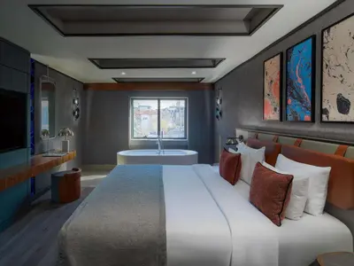 a bedroom with a large bed and a bath tub at Mercure Istanbul Altunizade in Istanbul