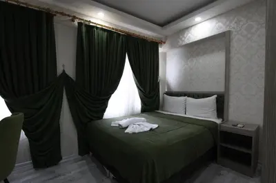 a bedroom with a green bed with a window at Kaya Madrid Hotel in Istanbul