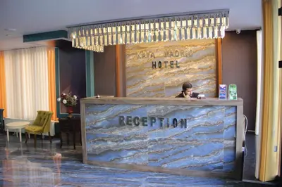 a woman sitting at a reception desk in a hotel lobby at Kaya Madrid Hotel in Istanbul
