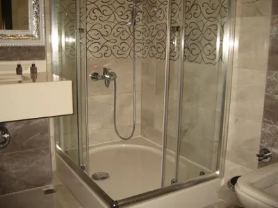 a shower with a glass door in a bathroom at Termal Elit Hotel in Gokcedere