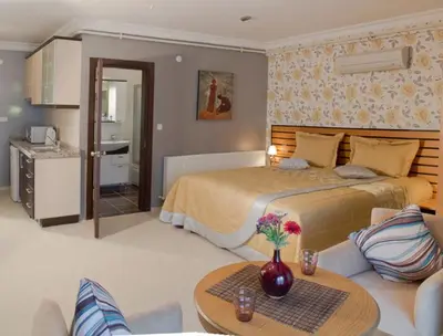 a bedroom with a large bed and a living room at The Bosphorus House in Istanbul