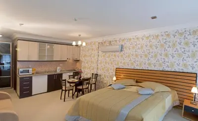 a bedroom with a large bed and a kitchen at The Bosphorus House in Istanbul