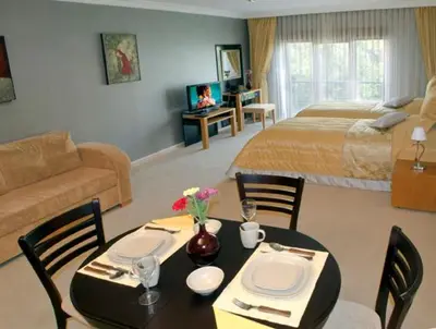 a living room with a dining table and a bedroom at The Bosphorus House in Istanbul