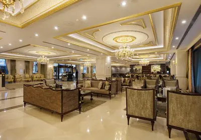 a hotel lobby with chairs and tables and chandeliers at Ottoman's Life Hotel Deluxe in Istanbul