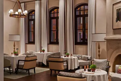 a restaurant with tables and chairs and a fireplace at Four Seasons Hotel Istanbul at Sultanahmet in Istanbul