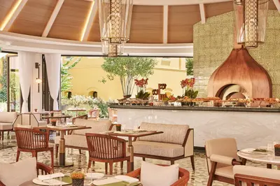 a restaurant with tables and chairs and a fireplace at Four Seasons Hotel Istanbul at Sultanahmet in Istanbul
