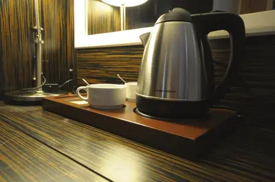 a coffee maker and a cup on a wooden tray at Ottopera Hotel in Istanbul