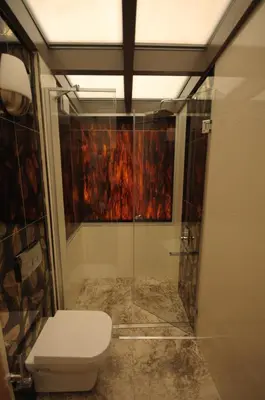 a bathroom with a toilet and a glass shower at Ottopera Hotel in Istanbul
