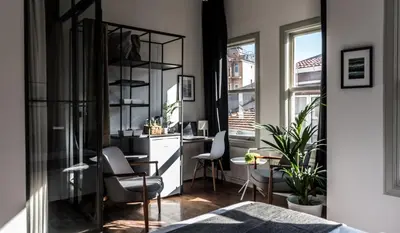 a living room with a desk and chairs in a room at HAUS Galata in Istanbul