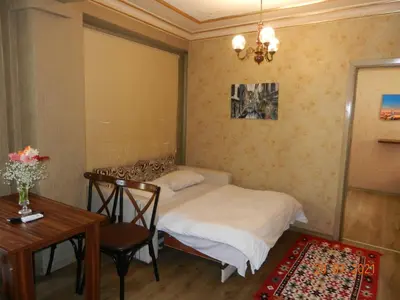 a small bedroom with a bed and a table at Royal Suites Sultanahmet in Istanbul
